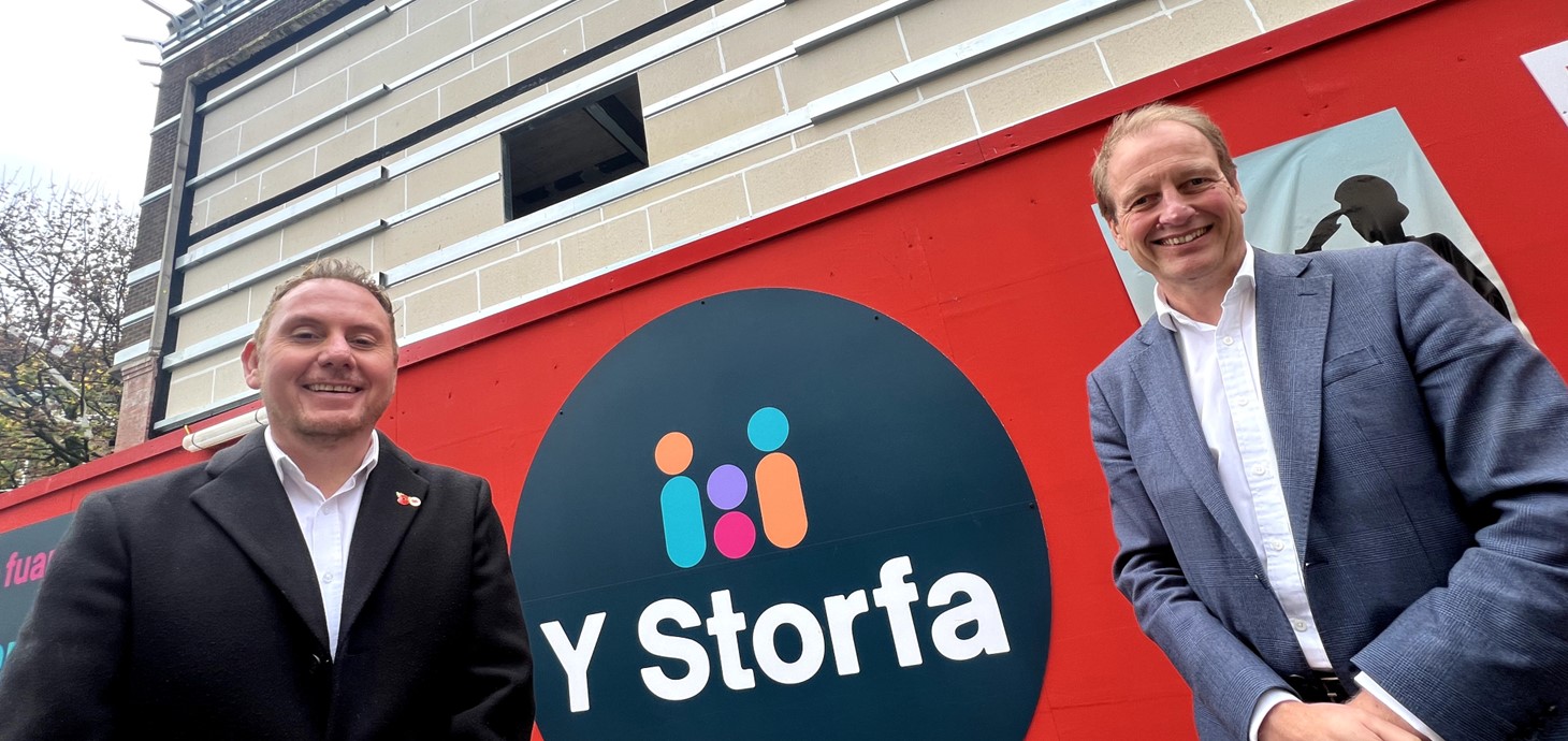 Two men standing in front of a building